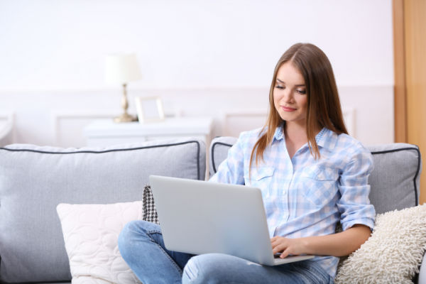 Young beautiful woman with laptop at home